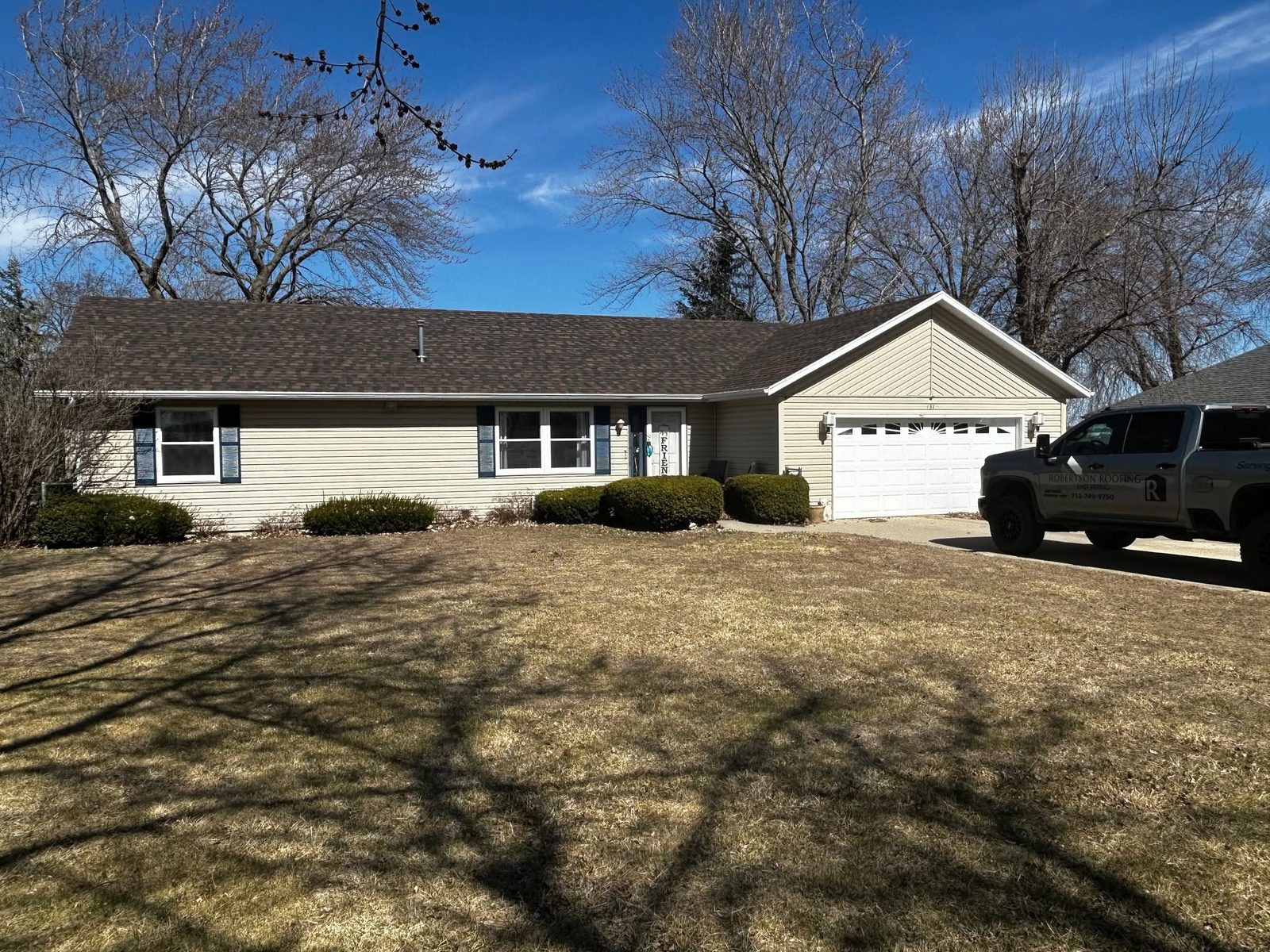 Robertson Roofing residential roof inspection with service truck